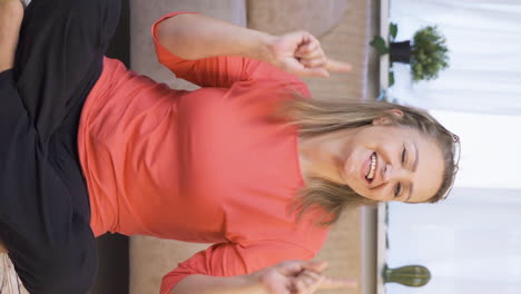 Vertical-video-of-Woman-doing-rocker-sign-and-dancing.